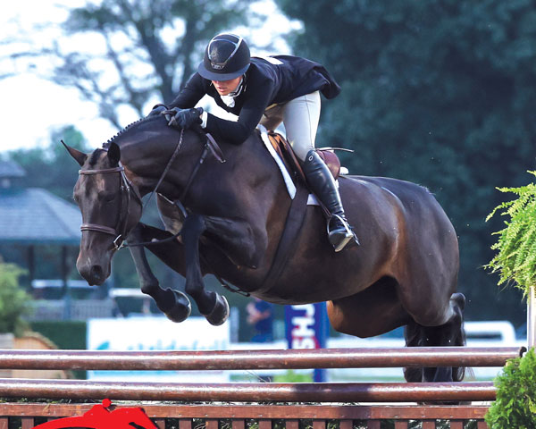 Eleanor Rudnicki and Vex Freedom jumping a hunter fence