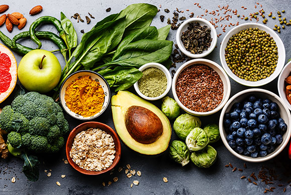 table top full of vegetables, fruits, and seeds